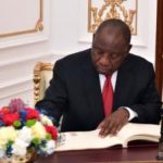 cyril-ramaphosa-signing-alone-office-wearing-black-suit_0